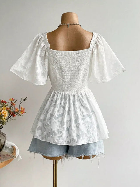 Back view of Floral Tie-Front Smocked Back Flutter Sleeve Blouse  on mannequin featuring tie front, smocked waist, and feminine flutter sleeves