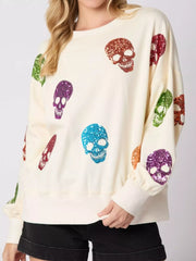 Halloween Colorful Skull Sequin Oversized Sweatshirt with colorful sequin skulls on a cream background.