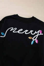 MERRY Sequin Lounge Set - close-up of embroidered text on black fabric with colorful leaves