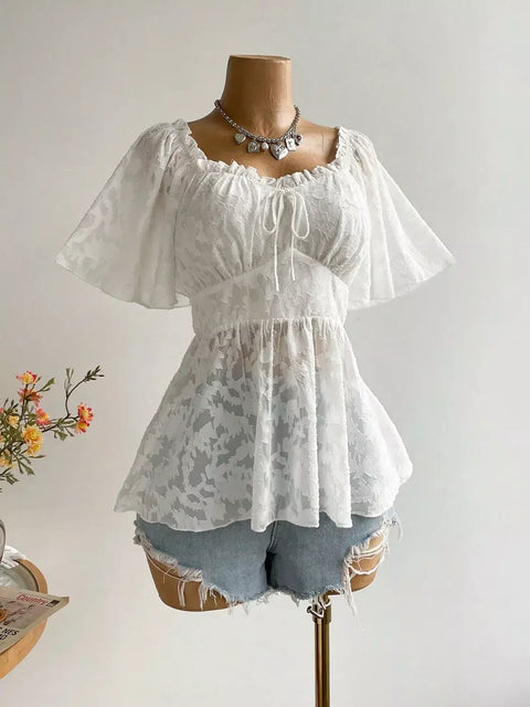 Close-up of Floral Tie-Front Smocked Back Flutter Sleeve Blouse  on mannequin showing tie-front neckline and frilled hem details
