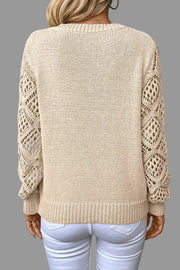 Back view of a V-Neck Crochet Sleeve Sweater featuring intricate crochet sleeves and a relaxed fit.