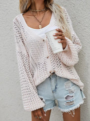 Stylish woman wearing an Openwork Button Front Cardigan, holding a coffee cup and paired with denim shorts.