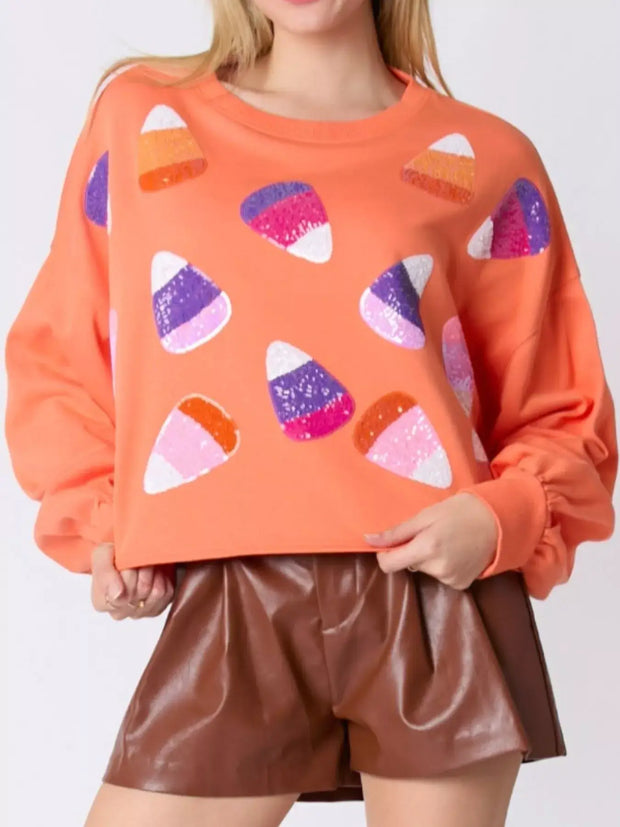 Halloween Candy Sequin Long-Sleeve Sweatshirt with vibrant candy designs for festive autumn style.