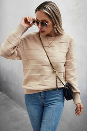 Classic Round Neck Loose Knit Sweater worn with jeans and sunglasses for a casual chic look.