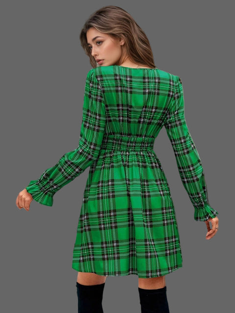 Back view of the Plaid Holiday Mini Dress – Smocked & Ruffled in green with a smocked waist and ruffled hem.