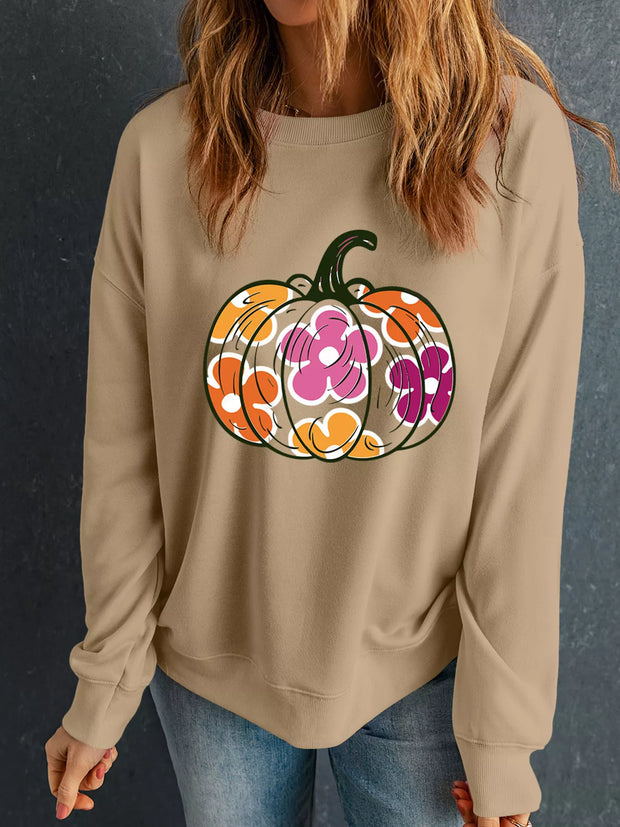 Woman wearing a Halloween Floral Pumpkin Graphic Drop-Shoulder Sweatshirt with a colorful floral pumpkin design.