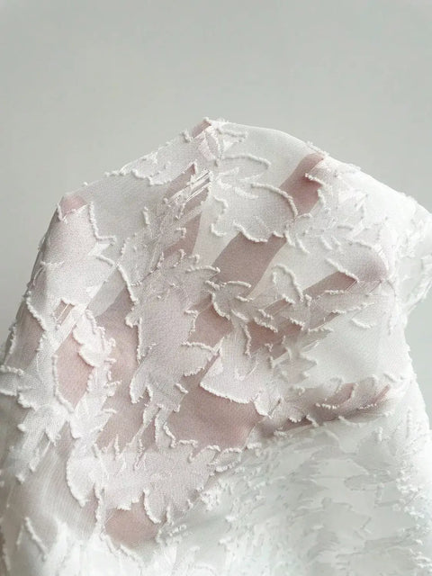 Close-up of the Floral Tie-Front Smocked Back Flutter Sleeve Blouse  fabric showing soft floral texture, delicate frill details, and lightweight material
