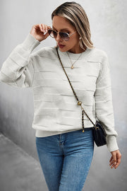 Classic Round Neck Loose Knit Sweater worn with blue jeans and sunglasses for a stylish casual look.