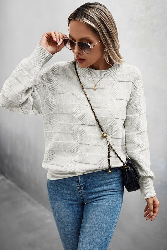 Classic Round Neck Loose Knit Sweater worn with blue jeans and sunglasses for a stylish casual look.