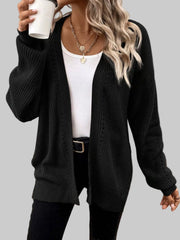 Woman wearing a black Supreme Comfort Open-Front Cardigan over a white top, styled for a chic, casual look.