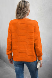 Back view of a woman wearing a Classic Round Neck Loose Knit Sweater in orange with a textured pattern.