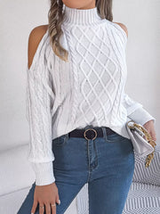 Model wearing a Cable Knit Cold Shoulder Turtleneck Sweater in white, styled with jeans and a handbag.