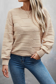 Model wearing a Classic Round Neck Loose Knit Sweater in beige, perfect for casual outings and all-day comfort.