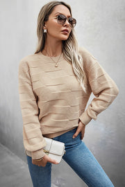 Classic Round Neck Loose Knit Sweater worn by a model, styled with jeans and sunglasses for a chic look.