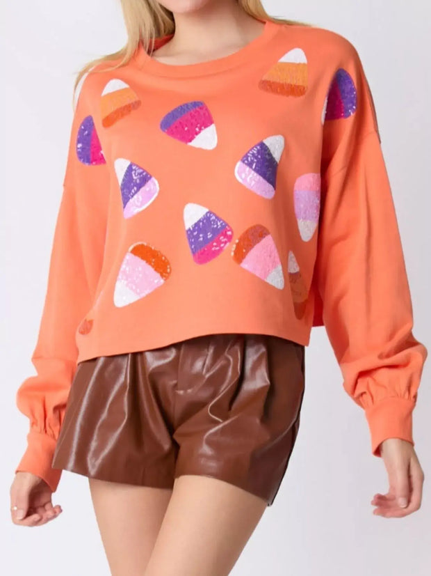Halloween Candy Sequin Long-Sleeve Sweatshirt with colorful candy design and relaxed fit for spooky season fun.