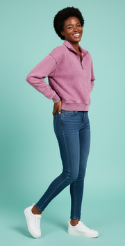Model wearing Zenana Acid Wash Fleece Half Zip Sweatshirt with jeans and white sneakers against a teal background.