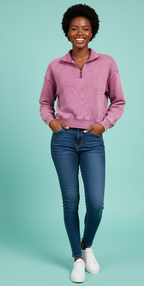 Model wearing a Zenana Acid Wash Fleece Half Zip Sweatshirt with jeans on a blue background.
