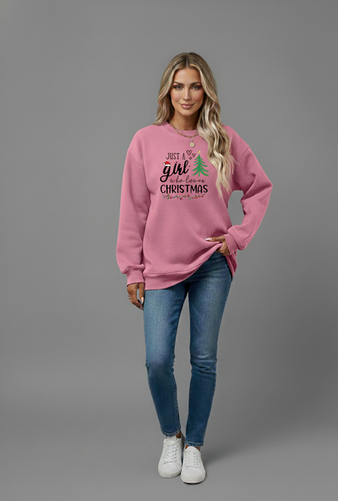 Woman wearing a pink Letter Graphic Round Neck Sweatshirt with Christmas design, styled casually with jeans.