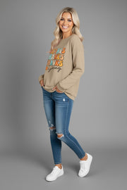 Side view of a model wearing a THANKSGIVING Round Neck Dropped Shoulder Sweatshirt worn with jeans, featuring a stylish design for the festive season.