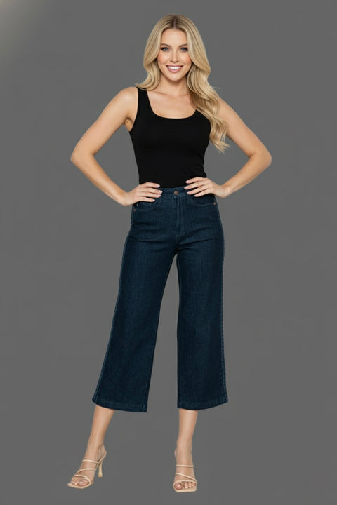 Model wearing Judy Blue Side Seam Braid Crop Wide Leg Jeans with a black tank top on a gray background.