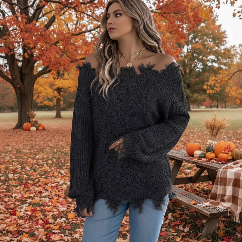 Woman wearing black off-the-shoulder distressed sweater with jeans in a fall park – cozy autumn outfit from A Keeper’s Journey