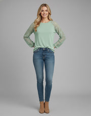 Model wearing the Lace Detail Seam Top featuring lace accents on sleeves for a classic everyday style.