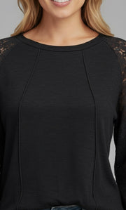 Model wearing the Lace Detail Seam Top featuring lace accents on sleeves for a classic everyday style.