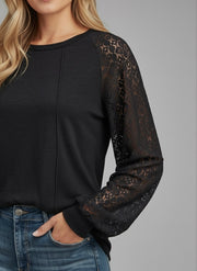 Model wearing the Lace Detail Seam Top featuring lace accents on sleeves for a classic everyday style.