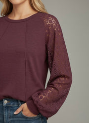 Model wearing the Lace Detail Seam Top featuring lace accents on sleeves for a classic everyday style.