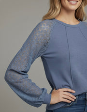 Model wearing the Lace Detail Seam Top featuring lace accents on sleeves for a classic everyday style.