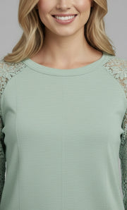 Model wearing the Lace Detail Seam Top featuring lace accents on sleeves for a classic everyday style.