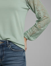 Model wearing the Lace Detail Seam Top featuring lace accents on sleeves for a classic everyday style.