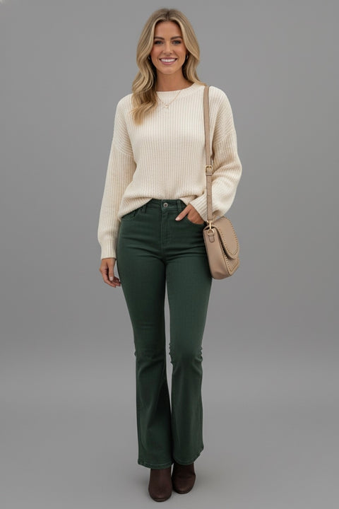 Model wearing Full Size Hight Waist Bootcut Pants Plus Size paired with a cream sweater and shoulder bag.