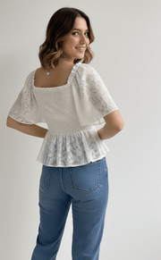 Back view of Floral Tie-Front Smocked Back Flutter Sleeve Blouse  with smocked detail and ruffle trim for a flattering fit