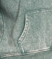 Close-up of the Zenana Fleece Acid Wash Kangaroo Pocket Hoodie showcasing the unique acid wash texture and pocket detail.