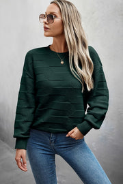 Classic Round Neck Loose Knit Sweater worn with jeans and sunglasses, showcasing a stylish and relaxed look.