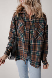 Model wearing brown plaid button-up shacket styled with jeans for a casual fall look
