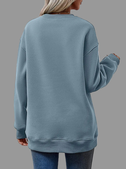 Back view of a woman wearing a Letter Graphic Round Neck Sweatshirt in blue color, showcasing the relaxed fit and cozy fabric.