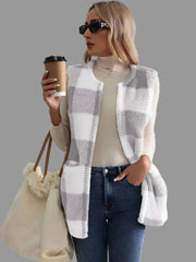 Woman wearing a Plaid Sherpa Vest Coat with a coffee, styled for an effortless everyday look.