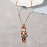 18K Gold Nutcracker Pendant Necklace featuring a rhinestone-encrusted Nutcracker charm on a delicate gold chain.