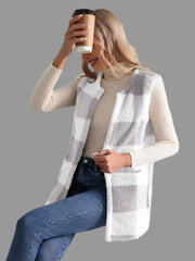 Woman wearing a Plaid Sherpa Vest Coat, holding a coffee cup, showcasing effortless everyday style.