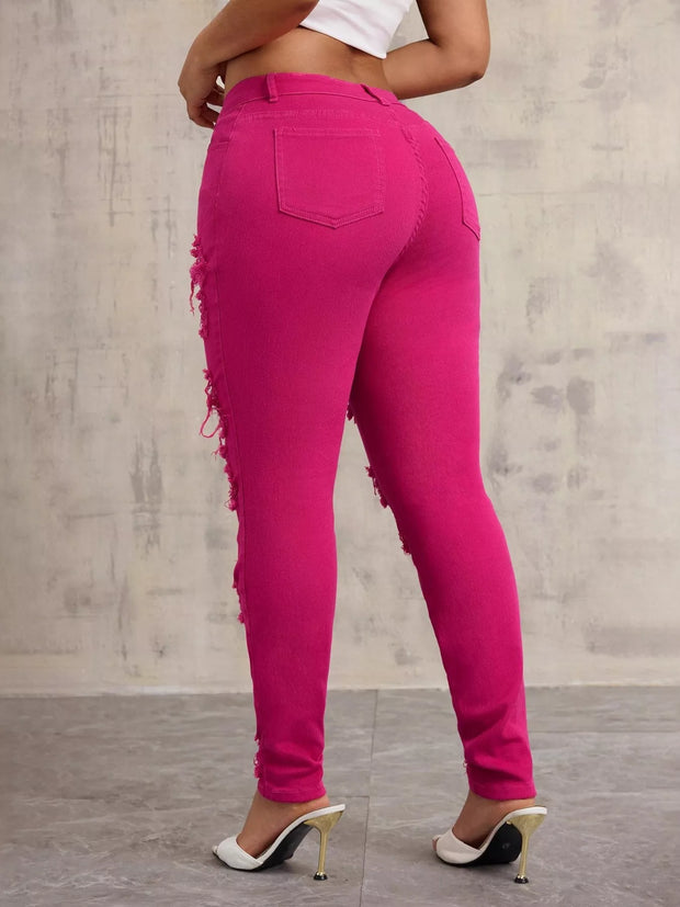 High-Waisted Distressed Skinny Jeans – Classic Denim Fit in vibrant pink shown from the back with distressed detailing.