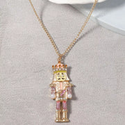18K Gold Nutcracker Pendant Necklace featuring a rhinestone-encrusted Nutcracker charm on a delicate gold chain.