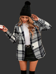 Plaid Single-Button Blazer styled with a white top and skirt, showcasing winter fashion in a stone archway setting.