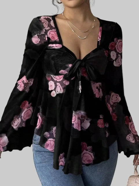 Floral Tie-Front Blouse with a v-neckline and flutter sleeves, showcasing a romantic floral pattern in pink and black.