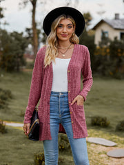 Ribbed Button-Up Cardigan with Pockets worn by a model outdoors, featuring a casual look with V-neck and long sleeves.