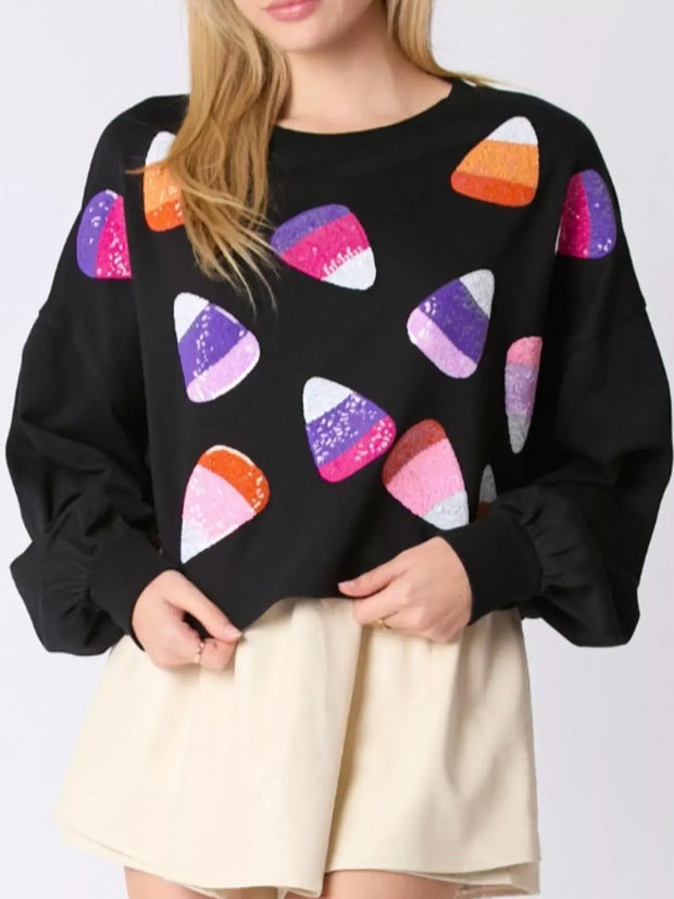 Halloween Candy Sequin Long-Sleeve Sweatshirt featuring colorful candy corn sequins on a black background.
