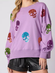 Halloween Colorful Skull Sequin Oversized Sweatshirt featuring vibrant sequin skulls on a lavender background.