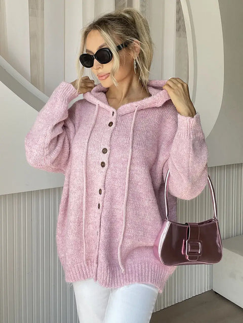 Drawstring Button Down Hooded Cardigan in pink, featuring buttons, drawstring, and pockets, styled with sunglasses and a handbag.