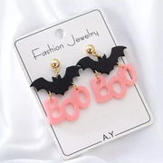 Halloween Bat “Boo” Dangle Earrings – Spooky Cute Statement Jewelry displayed on a card with playful bat charms.